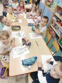 Przedszkolaki przygotowują kolorowanki z kropkami.