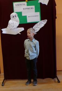 Uczeń klasy I w czasie występu w Szkolnym Konkursie Recytatorskim, zdj. 4.